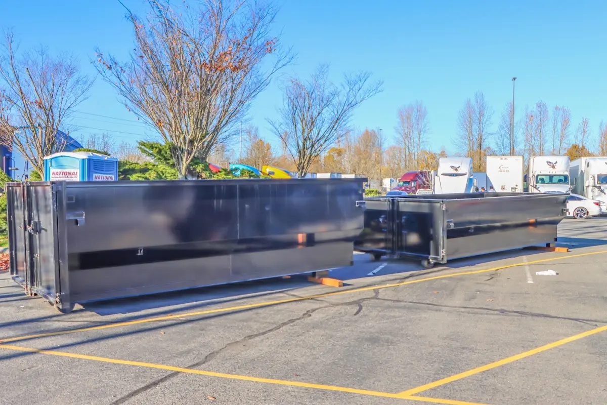 Professional dumpster rental service with roll-off container on residential driveway in Dearborn Heights